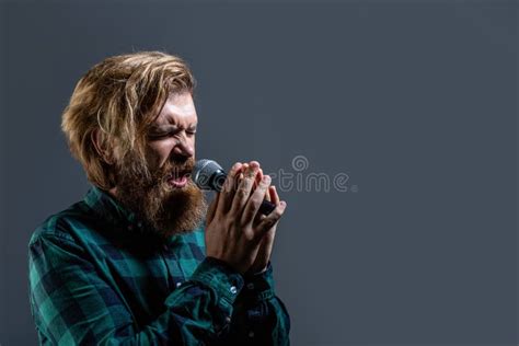 Male Attends Karaoke Bearded Man Singing With Microphone Male Singing With A Microphones Stock