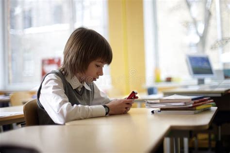 School Pupil Text Messaging On Cell Phone In Class Stock Image Image Of Elementary Person