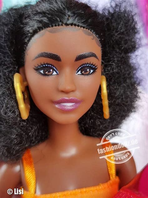 A Close Up Of A Barbie Doll With Long Hair And Big Hoop Earrings On Her