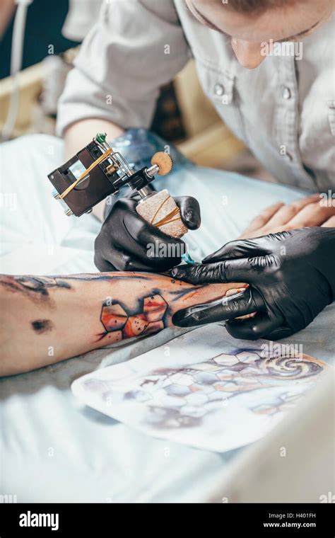 Concentrated Artist Tattooing Design On Human Hand Stock Photo Alamy