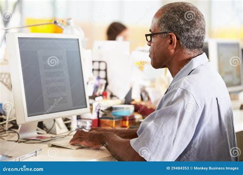 Man Working At Desk In Busy Creative Office Stock Image Image Of