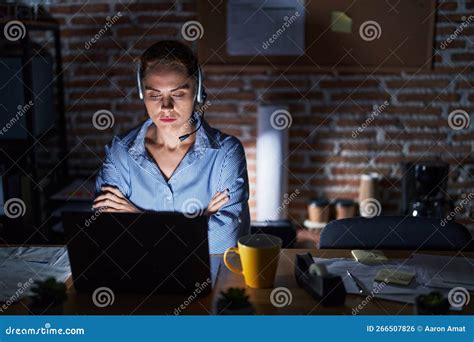 Beautiful Brunette Woman Working At The Office At Night Skeptic And Nervous Disapproving