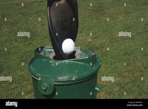 A Golf Ball Washer with golf ball Stock Photo - Alamy