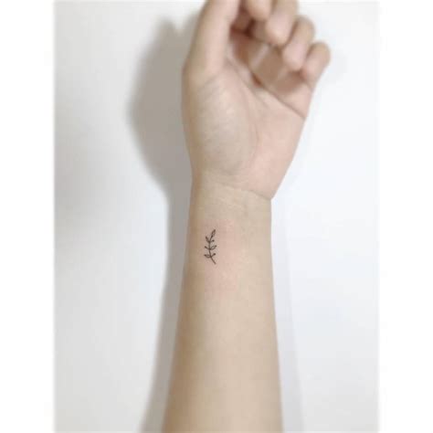 Tiny Sprig Tattoo Placed On The Wrist Minimalistic