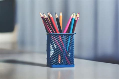 A Blue Container Of Colored Pencils With A Blue Container Of Colored