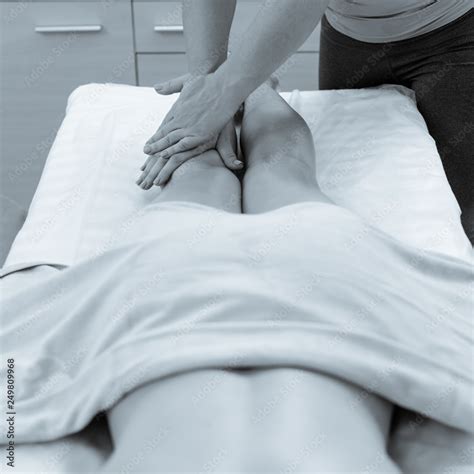 Woman With Naked Body Covered By Towel Receiving Feet Massage Photo Converted In Black And