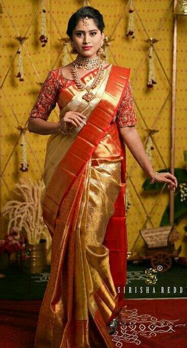 A Woman In A Red And Gold Sari