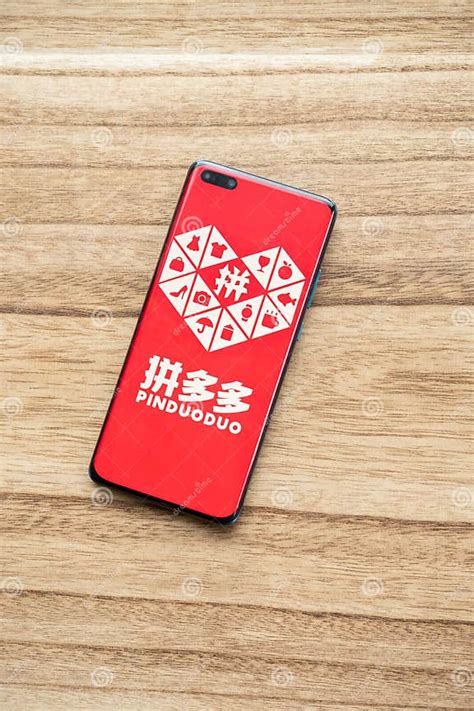 A Mobile with PinDuoDuo Logo at Vertical Composition Editorial Image ...