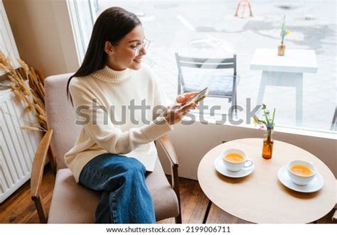 White Brunette Woman Smiling Using Mobile Stock Photo Shutterstock