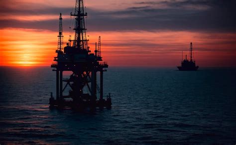 Premium Ai Image Oil Drilling Rig On The Sea At Sunset Oil And Gas