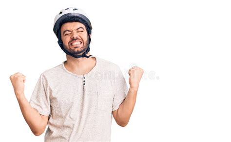 Young Hispanic Man Wearing Bike Helmet Very Happy And Excited Doing