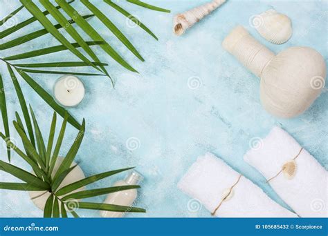 Flat Lay Top View Spa Background Thai Massage Bag Towels And Palm Leaves On Blue Background