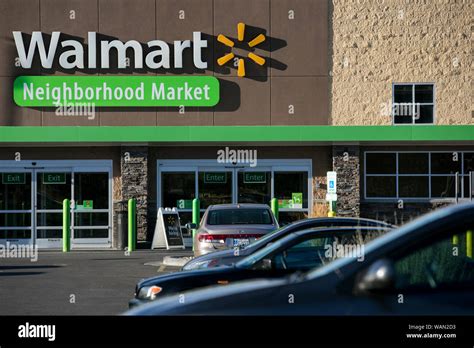 A Logo Sign Outside Of A Walmart Neighborhood Market Retail Store