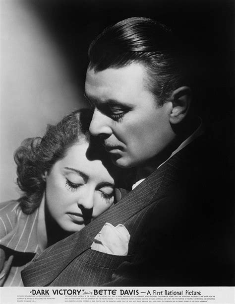 An Old Black And White Photo Of A Man Hugging A Woman S Head With Her