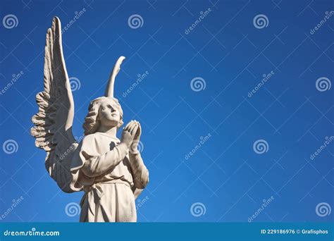 Sculpture of an Angel Praying Looking Up To Heaven Stock Photo - Image ...