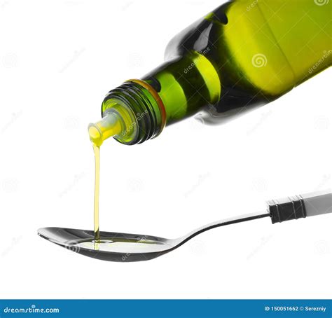 Pouring Olive Oil From Bottle Into Spoon On White Background Stock