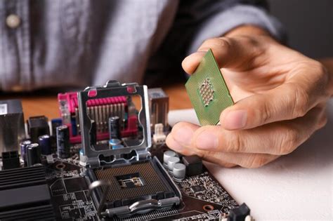 Premium Photo Technician Repairing Computer Motherboard At Table