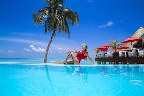 Elegant Woman In The Red Bikini On The Sun Tanned Slim And Shapely Body