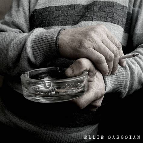 An Old Man Holding A Glass Bowl With Something In It S Hands And His Hand