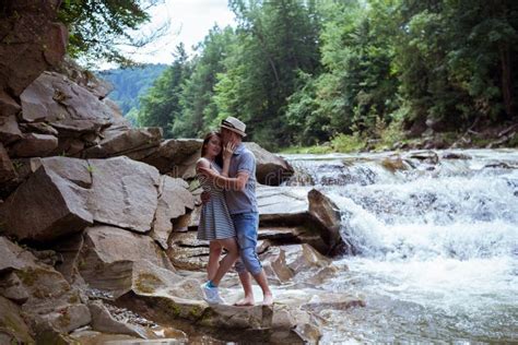 Couple Hugging And Kissing Near Waterfalls Stock Photo Image Of