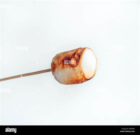 Roasted Marshmallows On A Skewer On White Background Stock Photo Alamy