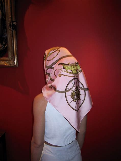 Pink Hermes head scarf, tied under chin | Beautiful silk scarves, Head scarf, Scarf styles