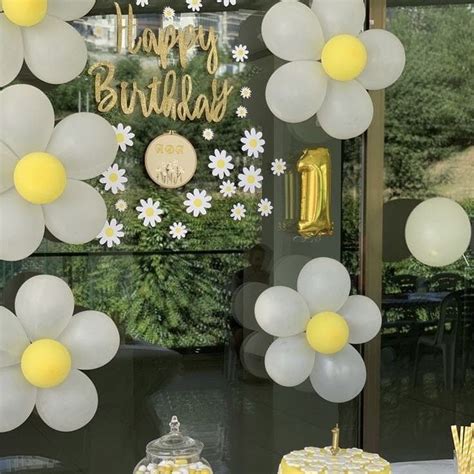 A Table Topped With Cake And Cupcakes Covered In Frosting Next To Balloons