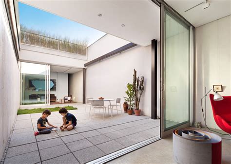 Courtyard House Is Shielded Behind A Metal Mesh Cage