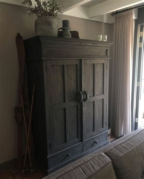 An Armoire In The Corner Of A Living Room