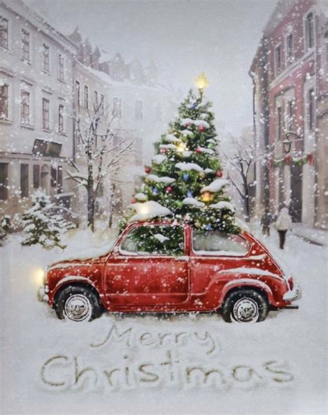 A Red Car Parked In Front Of A Christmas Tree With The Words Merry