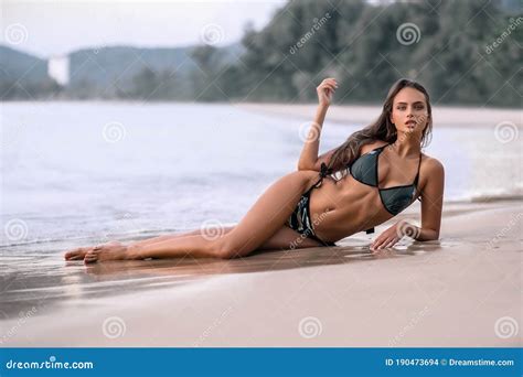 Amazing Sensual Seductive Woman Sitting And Resting On The Beach Enjoying Summer Holidays