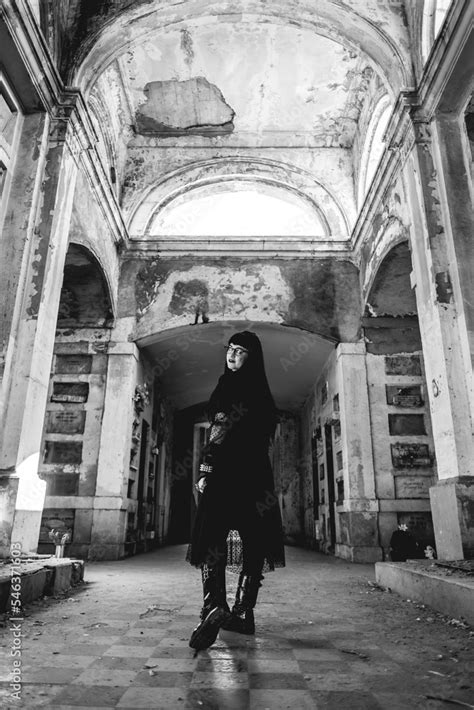 Dark Gothic Woman With Black Dress In Large Ancient Abandoned Mausoleum