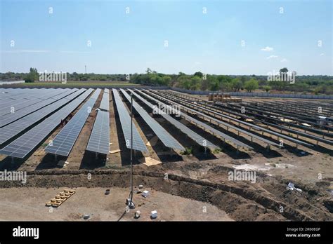 An Aerial View Of A Large Scale Solar Farm With An Array Of Black Solar