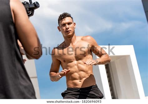 Muscular Man Fitness Influencer Recording Exercise Stock Photo