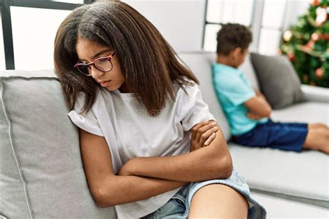 Brother And Sister Angry Having Problem Sitting On Sofa At Home Stock