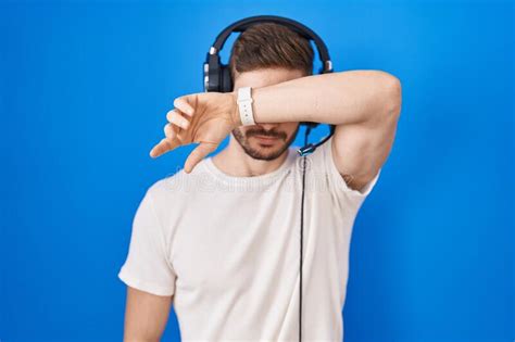 Hispanic Man With Beard Listening To Music Wearing Headphones Covering