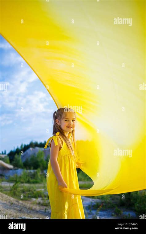 A Small 6 7 Years Old Ukrainian Girl In A Yellow Dress With Wings In