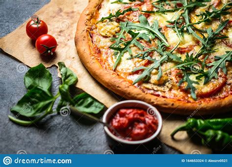 Traditional Italian Pizza With Ham Mozzarella Basil Arugula And