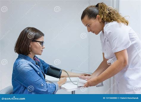 Nurse Taking Female Patient`s Blood Pressure in Office Stock Image ...