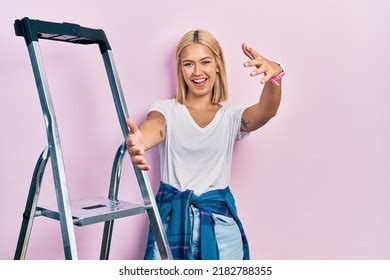 Beautiful Blonde Woman Standing By Ladder Stock Photo Shutterstock