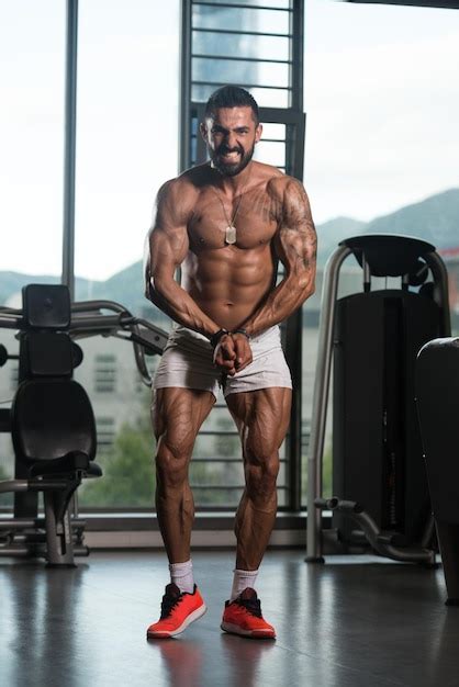 Premium Photo Serious Bodybuilder Standing In The Gym