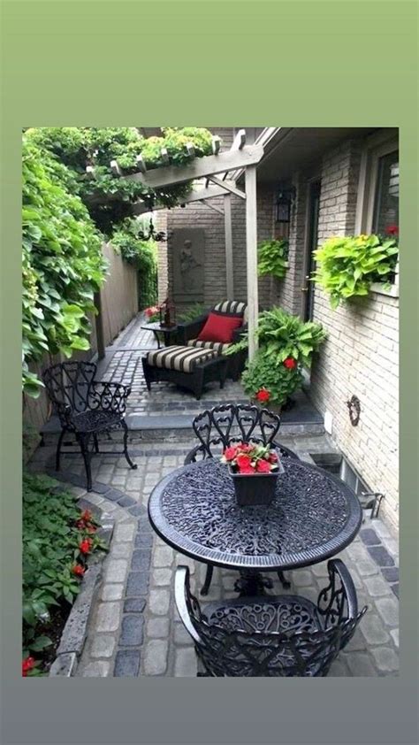 An Outdoor Patio With Chairs Table And Potted Plants