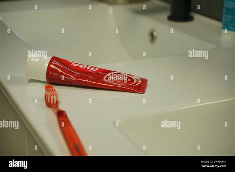 Red Colgate Toothpaste And Toothbrush On A Bathroom Counter Near The