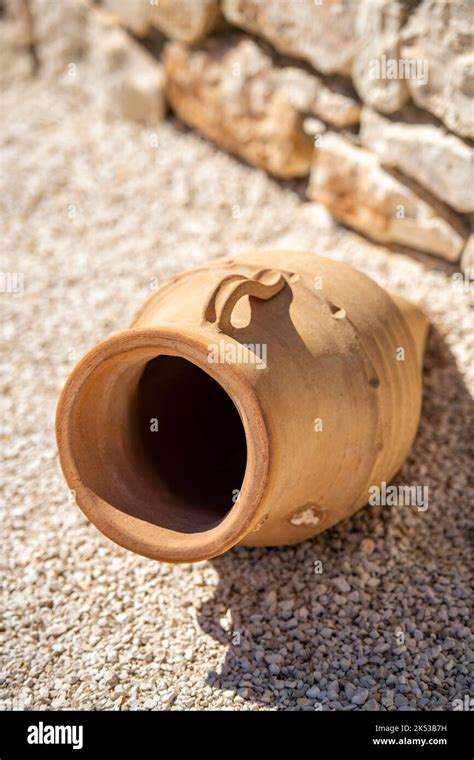 Traditional Greek Old Terracotta Olive Jar Lying On Its Side On Some