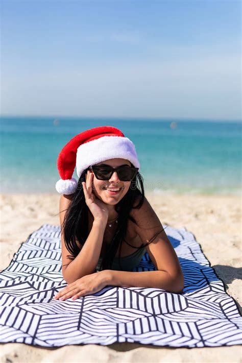 Christmas Beach Woman Wearing Santa Hat And Bikini Enjoying Winter Holidays On Tropical Beach