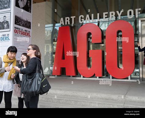 Exterior view of AGO Toronto. Tourists taking photographs. Art Gallery
