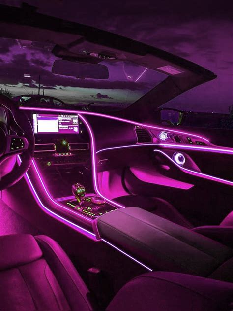 The Interior Of A Car With Purple Lighting