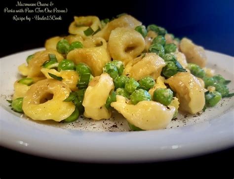 A White Plate Topped With Pasta And Peas
