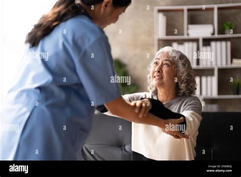 Young Caregiver Helping Senior Woman Walking Nurse Assisting Her Old