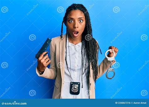 African American Police Woman Holding Gun And Handcuffs Afraid And